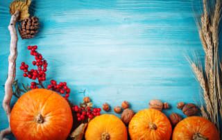 pumpkins and decorations on a blue wood background