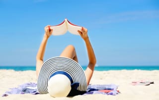 Photo of a Woman on Port Aransas Beach Doing Some Summer Reading.