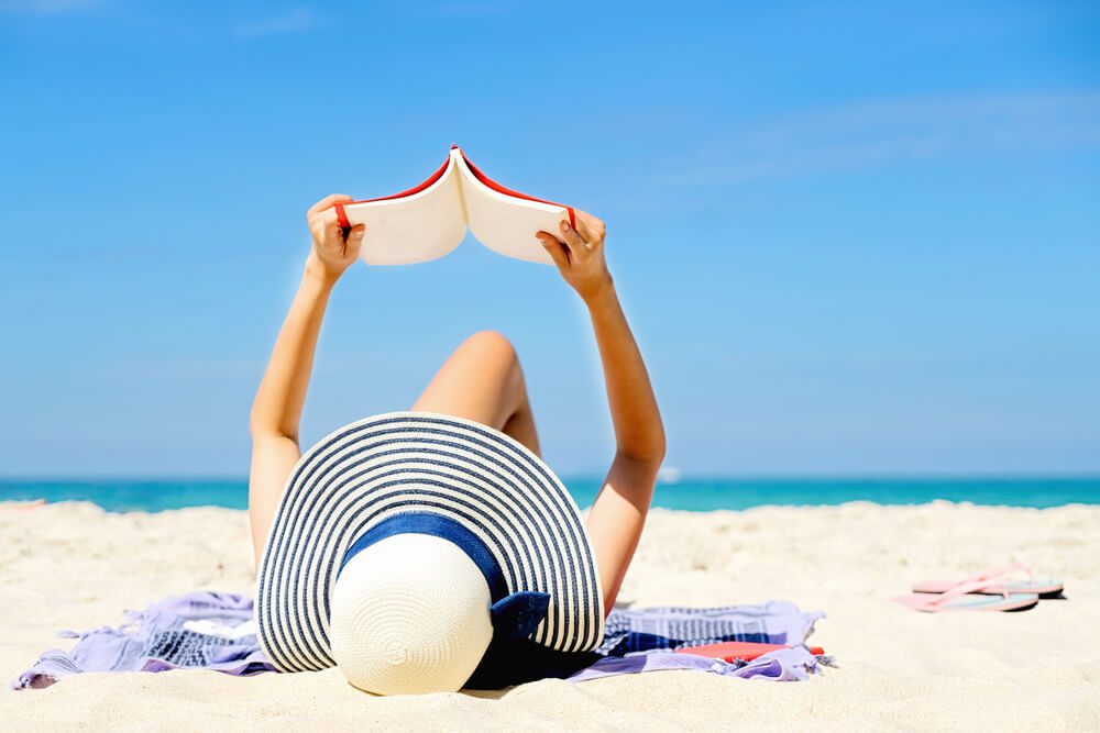 Photo of a Woman on Port Aransas Beach Doing Some Summer Reading.